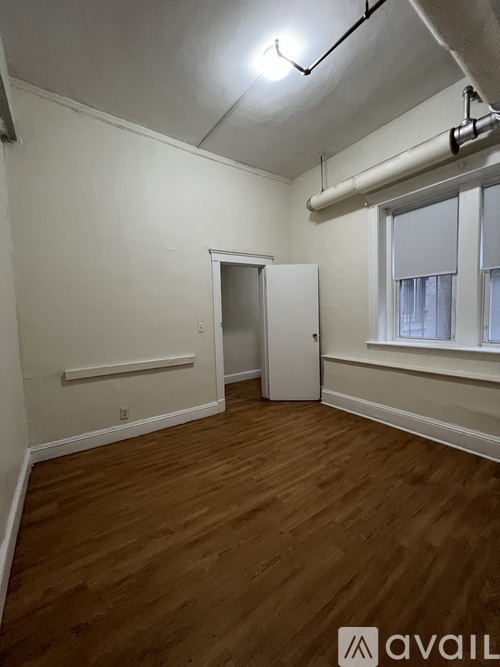 A room with wooden floors and a white door.
