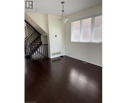A room with wooden floors and a staircase.
