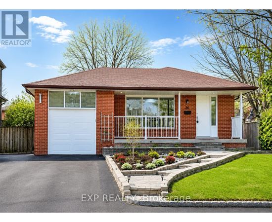 A red brick house with a white garage door and a white front door.
