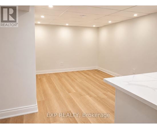 A room with EXP REALTY, Brokerage logo on the wall.