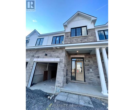 A house with a stone facade and a garage door is for sale.