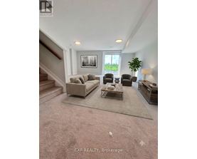A living room with a couch, chairs, and a coffee table.