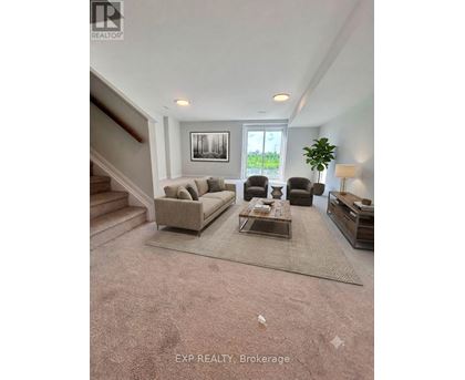 A living room with a couch, chairs, and a coffee table.