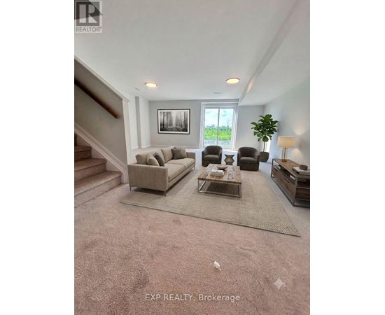 A living room with a couch, chairs, and a coffee table.
