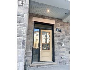 The door is numbered 207 and is part of a stone building.
