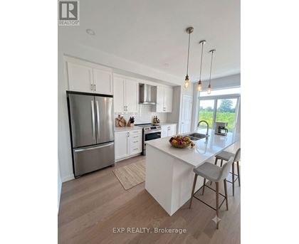 A modern kitchen with white cabinets and a large island.