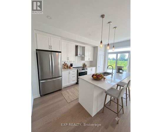 A modern kitchen with white cabinets and a large island.