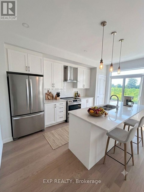 A modern kitchen with white cabinets and a large island.