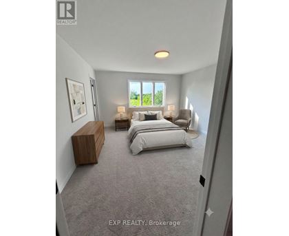 A bedroom with a large bed and a window overlooking a green area.