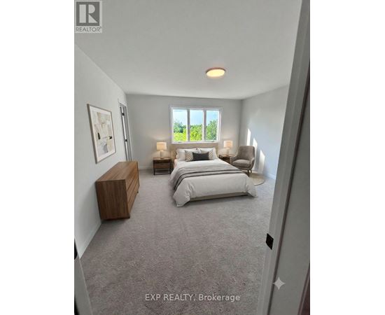 A bedroom with a large bed and a window overlooking a green area.
