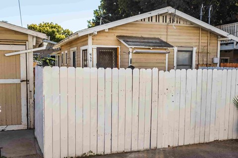 A white fence in front of a house.