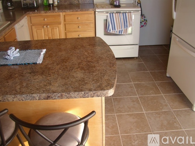 A kitchen with a brown counter top and a white oven.