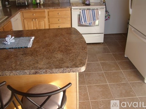A kitchen with a brown counter top and a white oven.