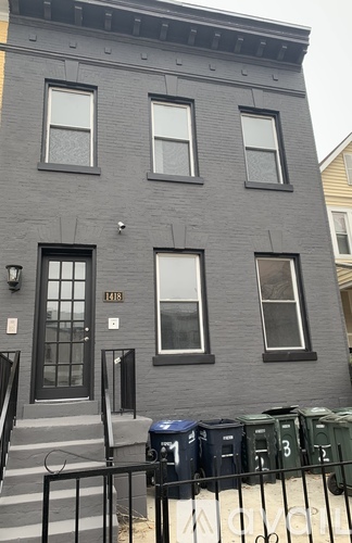 A grey building with the number 1141 on it.