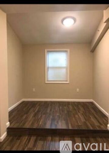 A room with wooden floors and a window.
