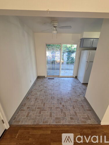 A room with a tiled floor and a ceiling fan.