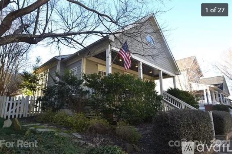 A house with a flag on the porch is for rent.