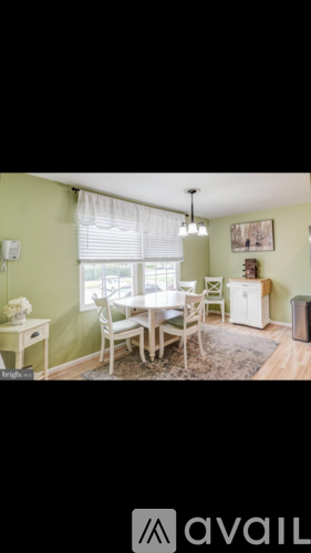 A dining room with a table set for four.