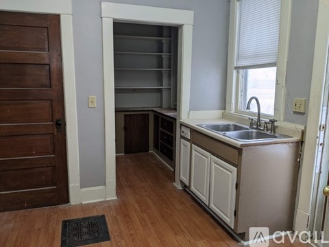A kitchen with a sink and a window.