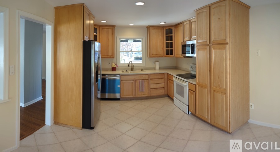 A kitchen with wooden cabinets and appliances.