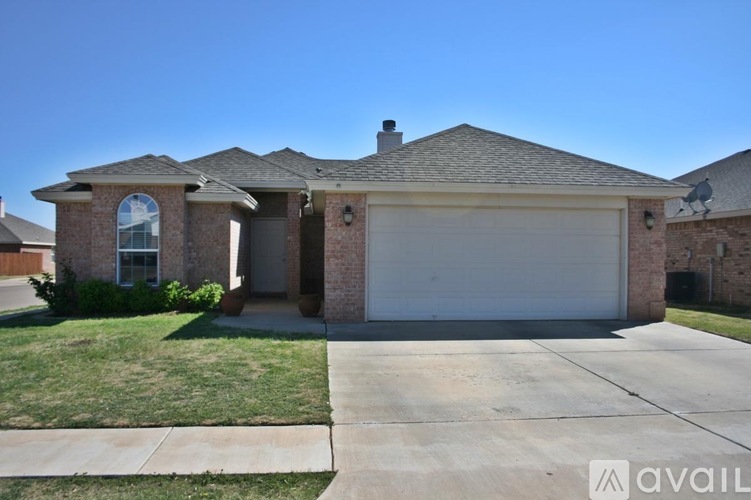 A house with a garage and a driveway is available for sale.