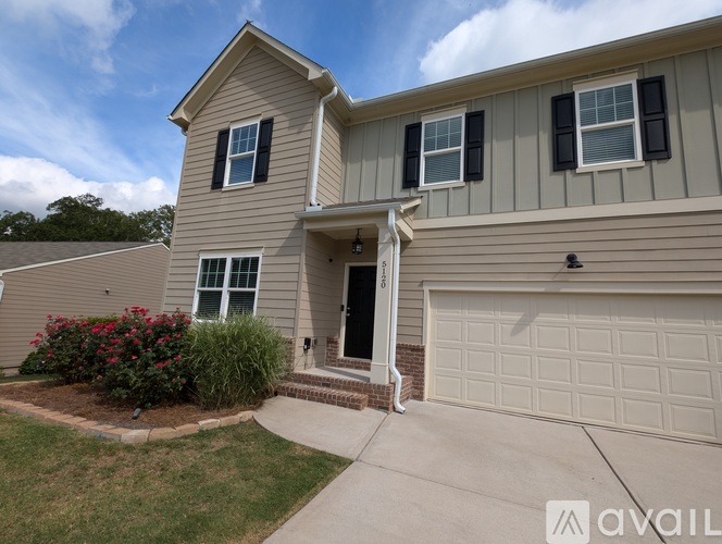 A house with a garage and a small front yard.