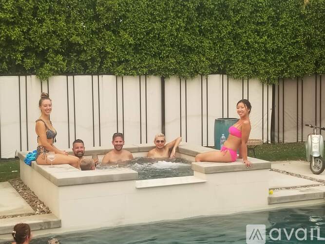 A group of people are enjoying a hot tub on a patio.