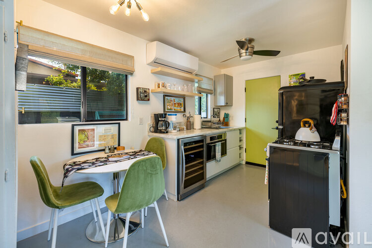 A kitchen with a table and chairs.