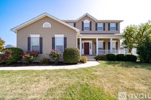 A house with a front yard and a red door.