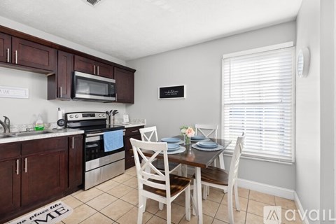 A kitchen with a dining table set for four.