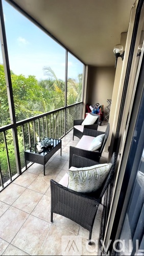 A balcony with a chair and a table.