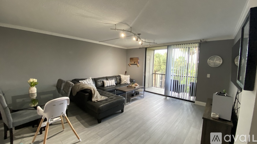 A living room with a grey couch and a white chair.