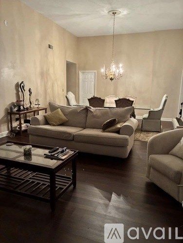 A living room with a large couch and a coffee table.