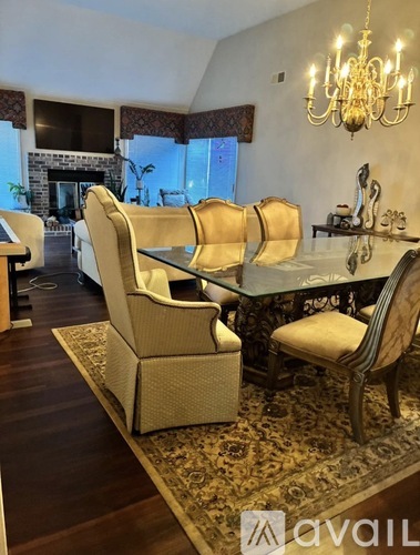 A dining room with a glass table and chairs.