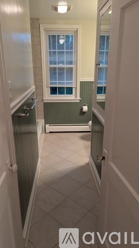 A hallway with a window and a door.