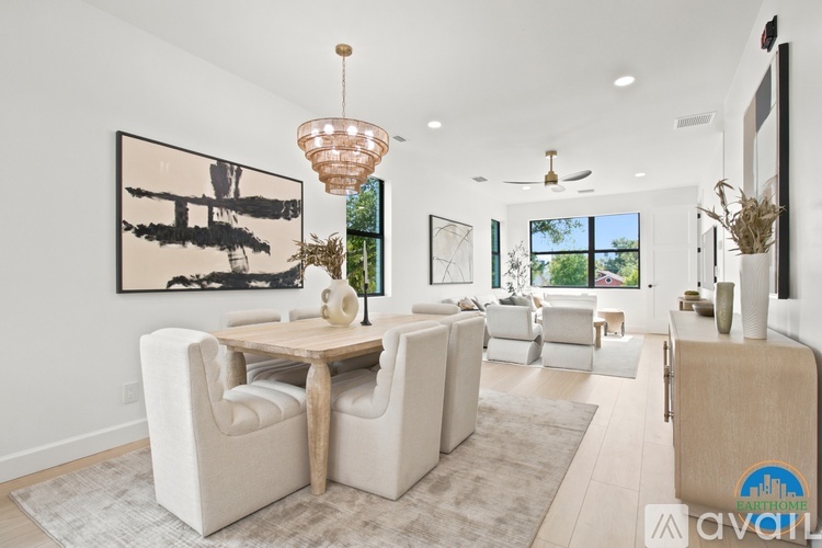 A living room with a white couch and a wooden table.