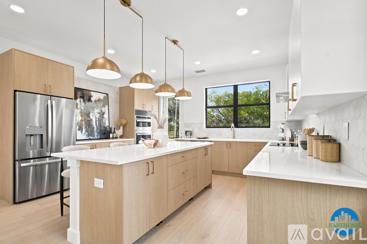 A modern kitchen with wooden cabinets and a white countertop.