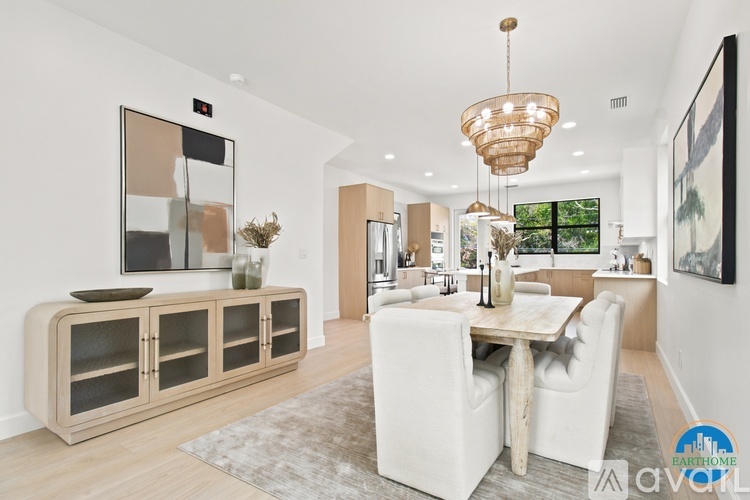 A modern dining room with a wooden table and chairs.