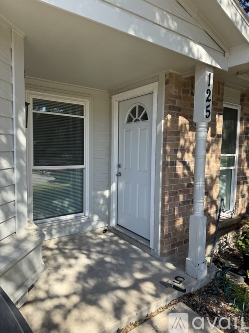 A white door is on the front of a house.