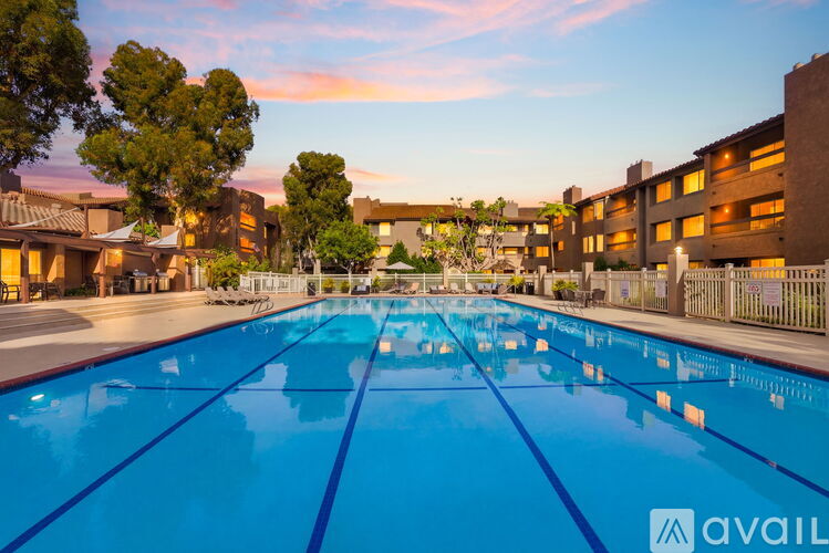 A large swimming pool in front of a building with the word "available" on it.