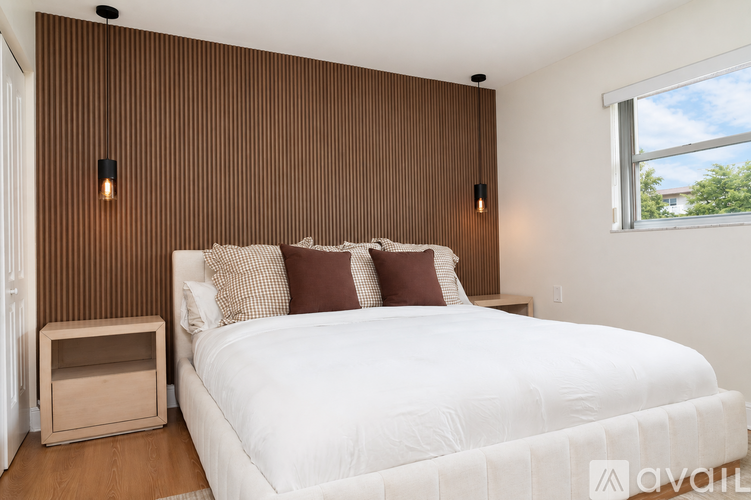 A bedroom with a large bed and a window.