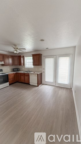 A kitchen with wooden cabinets and a white ceiling.