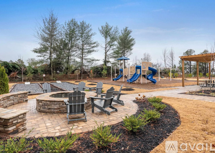 A playground with a blue slide and a wooden structure.