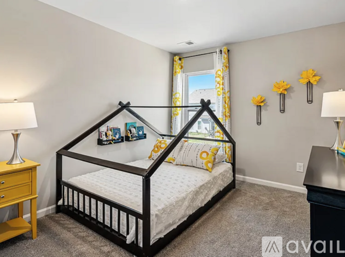 A bedroom with a white bed and a yellow lamp.