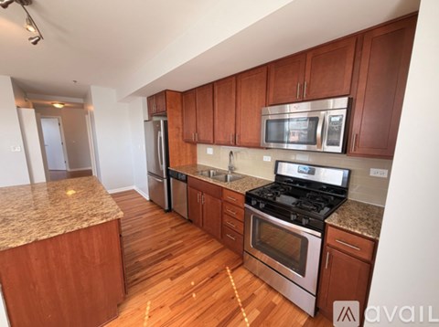 A kitchen with wooden cabinets and stainless steel appliances.