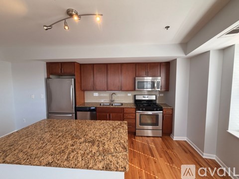 A kitchen with wooden cabinets and stainless steel appliances.