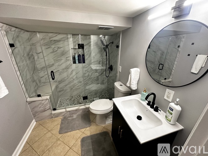 A bathroom with a sink, toilet, and shower.