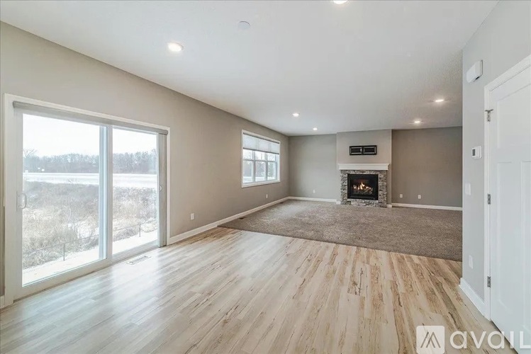 A spacious living room with a fireplace and sliding glass doors.