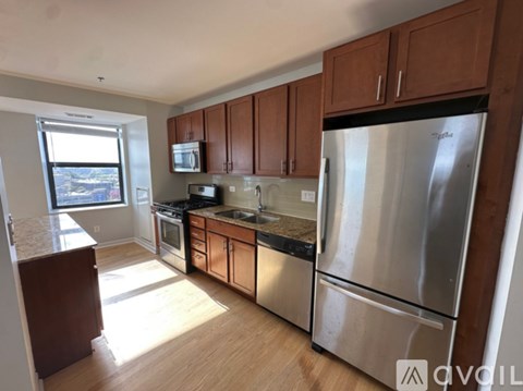 A kitchen with wooden cabinets and stainless steel appliances.
