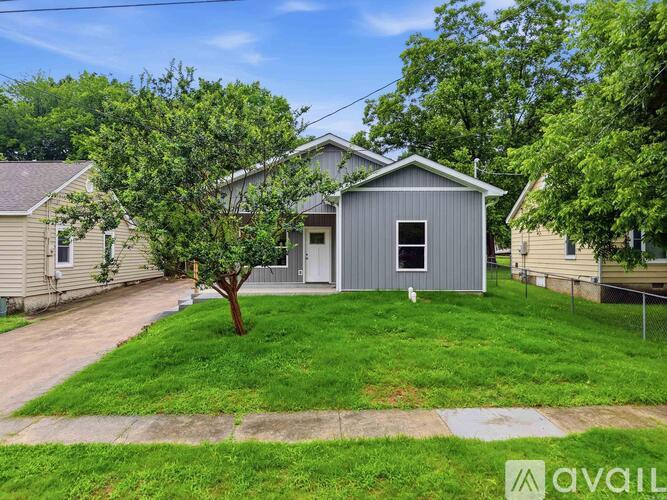 A house with a tree in front of it.